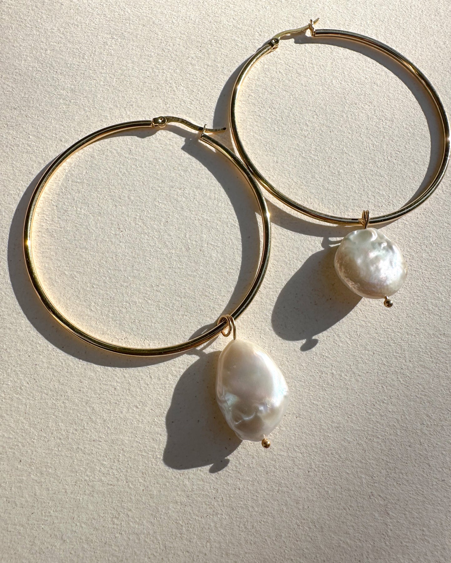 Gold plated hoops with pearls.