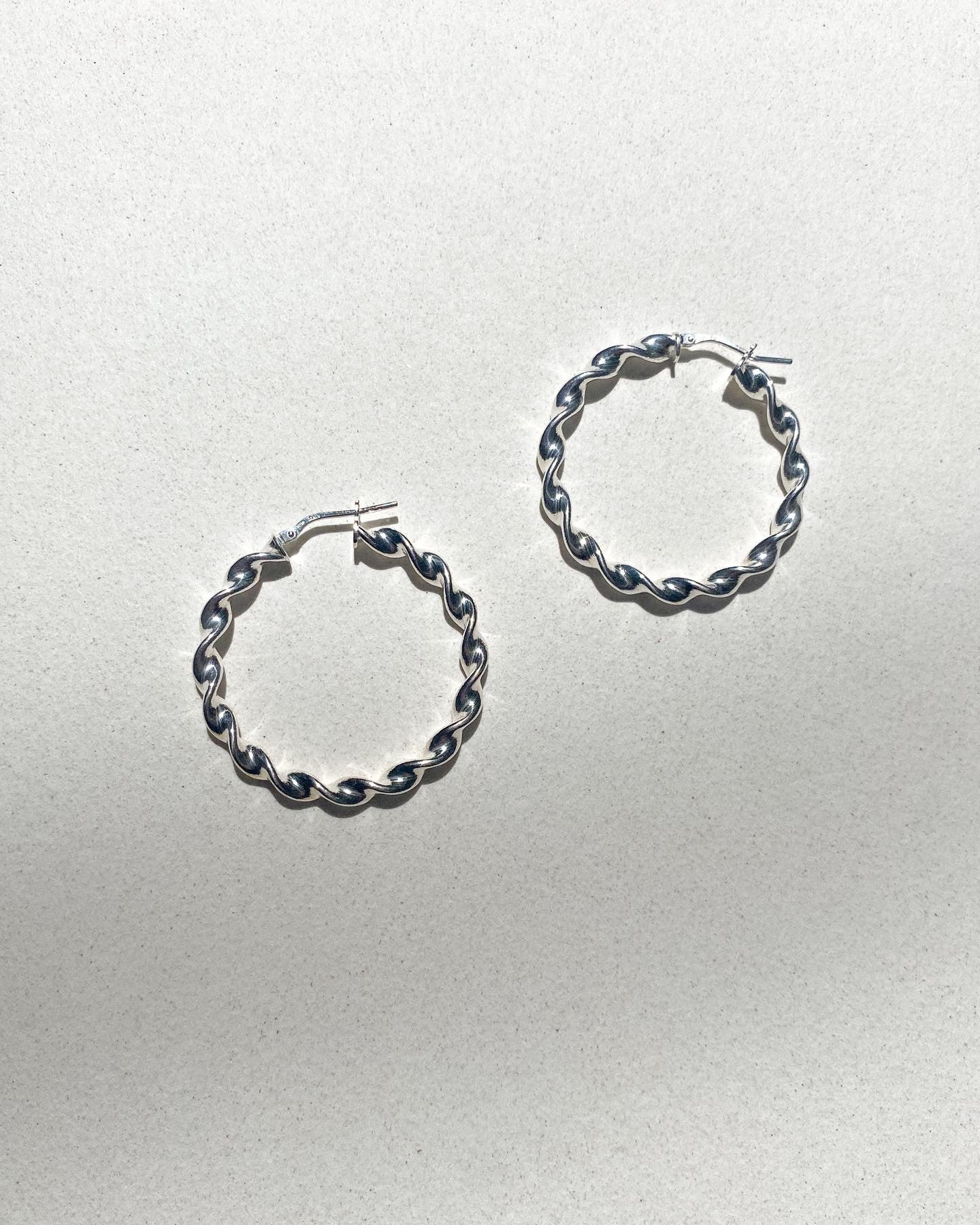 Twisted silver 925 hoops.
