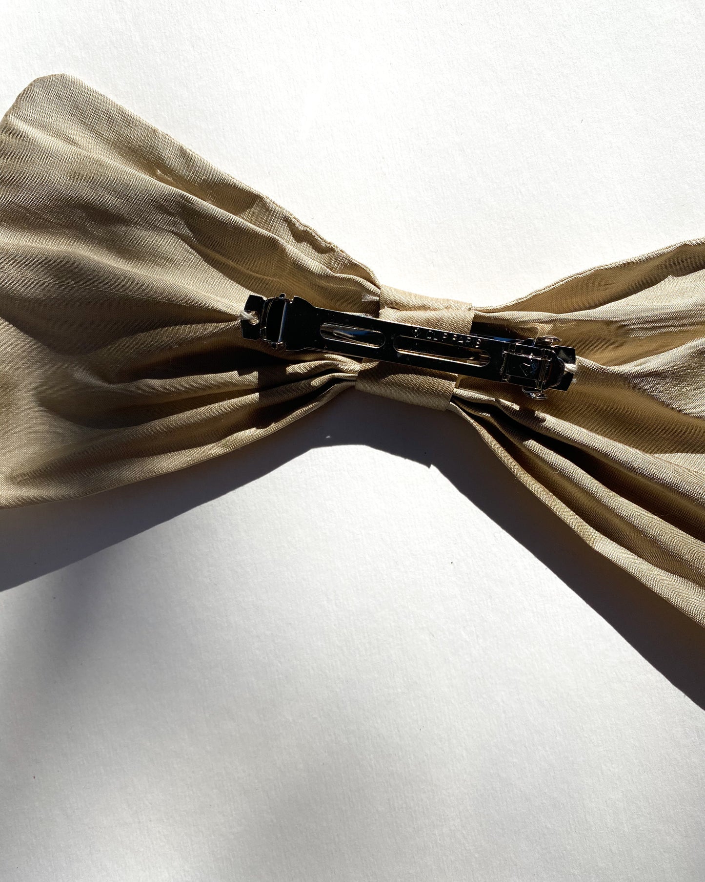 Classic raw silk bow barrette.